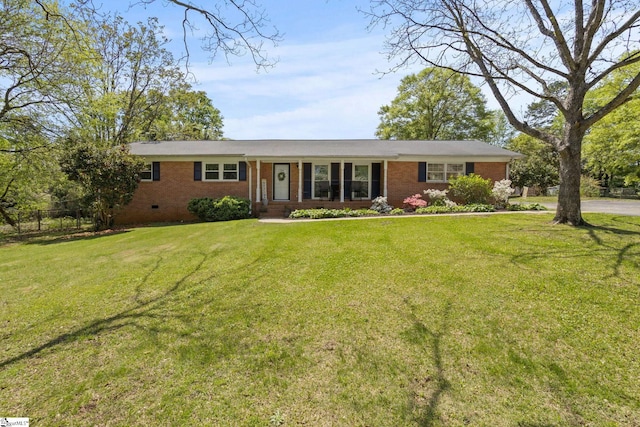ranch-style house featuring a front yard and brick siding