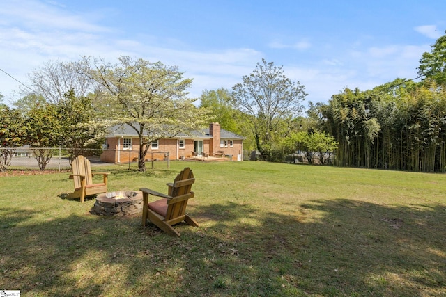 view of yard featuring fence and a fire pit
