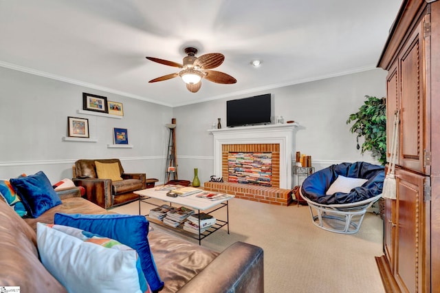 carpeted living room featuring crown molding, a ceiling fan, and a brick fireplace