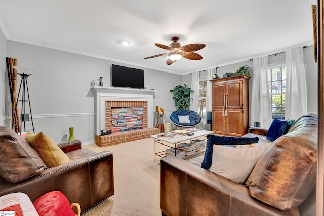 carpeted living room with crown molding, a ceiling fan, and a brick fireplace