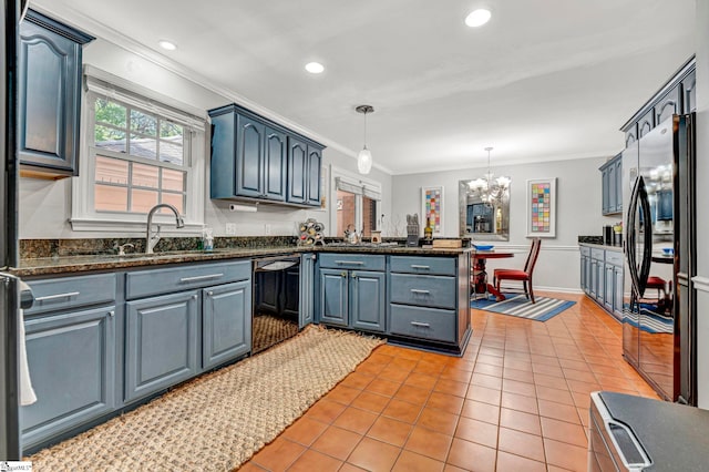kitchen with light tile patterned floors, a peninsula, black appliances, a chandelier, and a sink