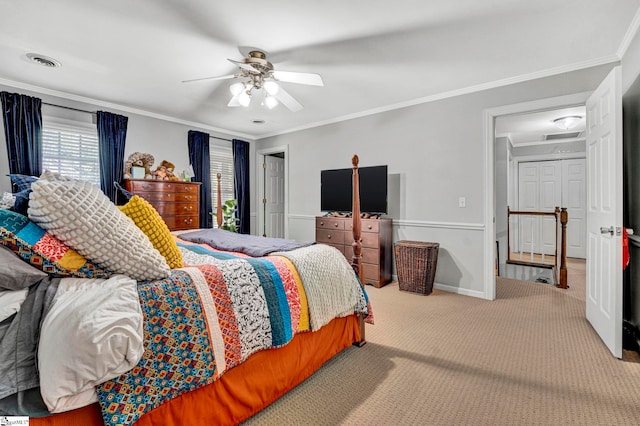 carpeted bedroom with ornamental molding, visible vents, baseboards, and a ceiling fan