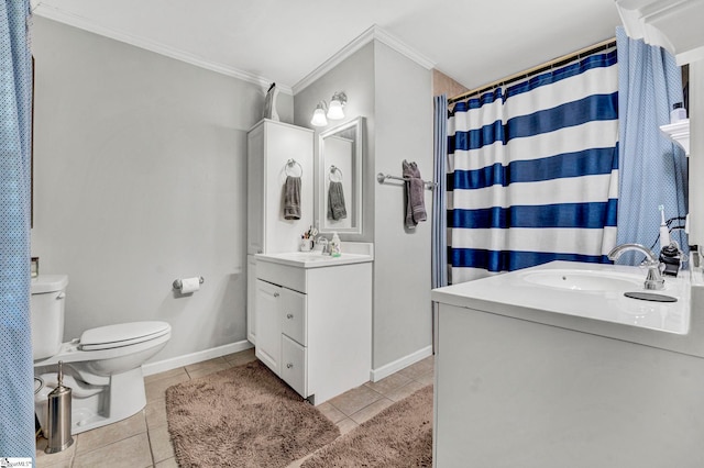bathroom with vanity, baseboards, tile patterned flooring, crown molding, and toilet