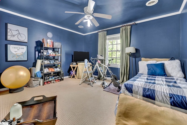 bedroom with crown molding, ceiling fan, visible vents, carpet flooring, and baseboards