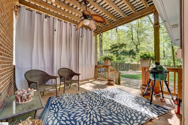 view of patio / terrace featuring ceiling fan and fence