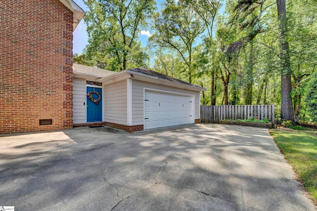 detached garage featuring fence