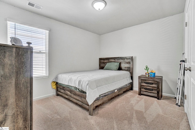 bedroom with visible vents, baseboards, and carpet