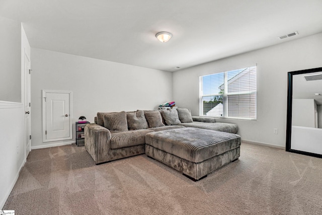 carpeted living room featuring visible vents and baseboards
