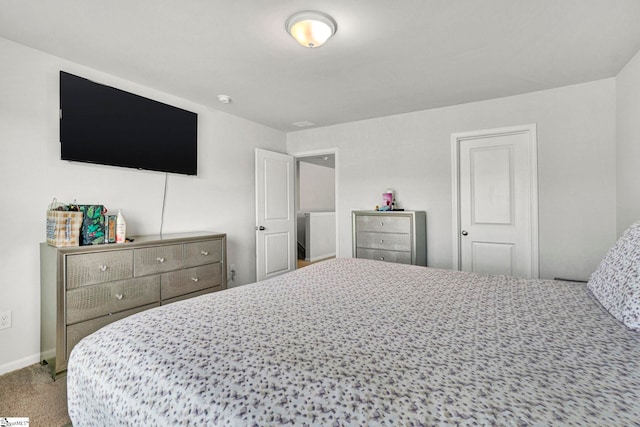 bedroom with carpet floors and baseboards