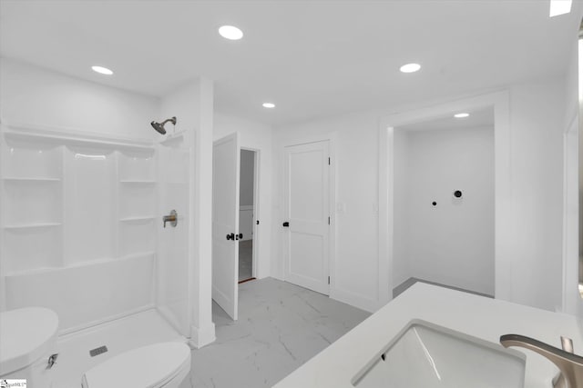 bathroom featuring toilet, recessed lighting, marble finish floor, and a stall shower