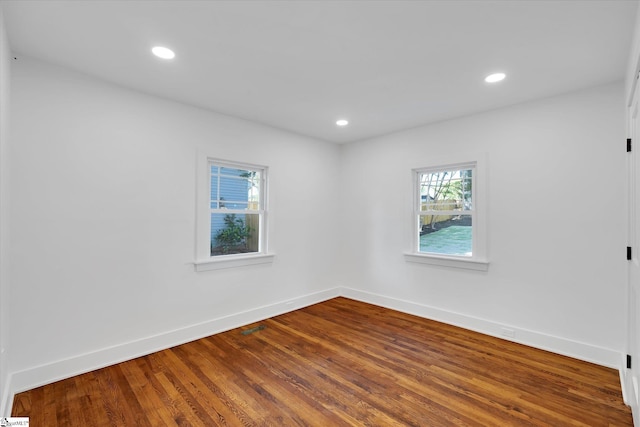 unfurnished room featuring baseboards, recessed lighting, and wood finished floors