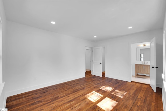unfurnished bedroom with recessed lighting, baseboards, and dark wood finished floors