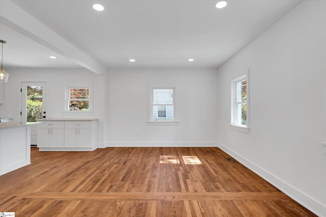 unfurnished room featuring recessed lighting, baseboards, and wood finished floors