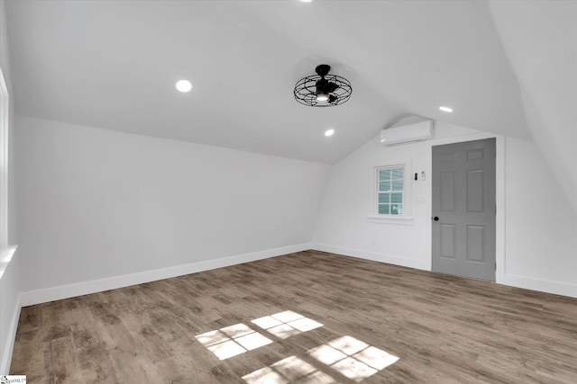 bonus room with a wall mounted AC, baseboards, vaulted ceiling, ceiling fan, and wood finished floors
