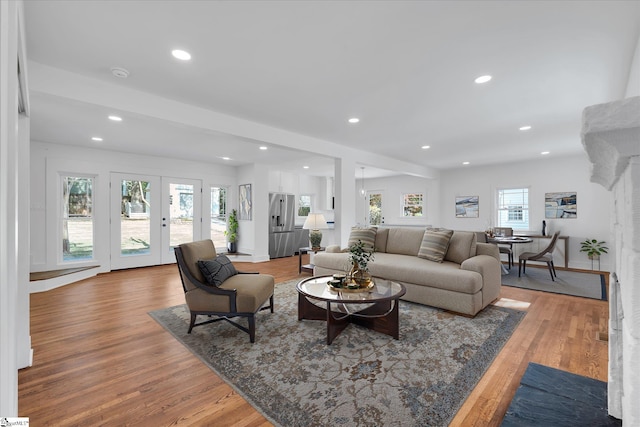 living area with recessed lighting, french doors, light wood-type flooring, and baseboards