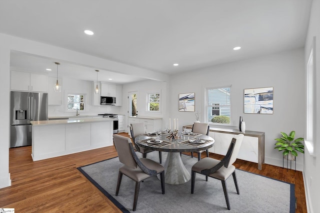 dining space featuring recessed lighting and wood finished floors