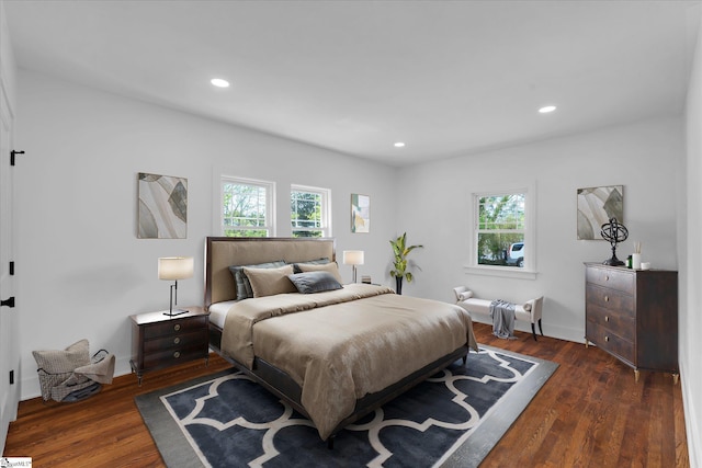 bedroom with recessed lighting and dark wood-type flooring