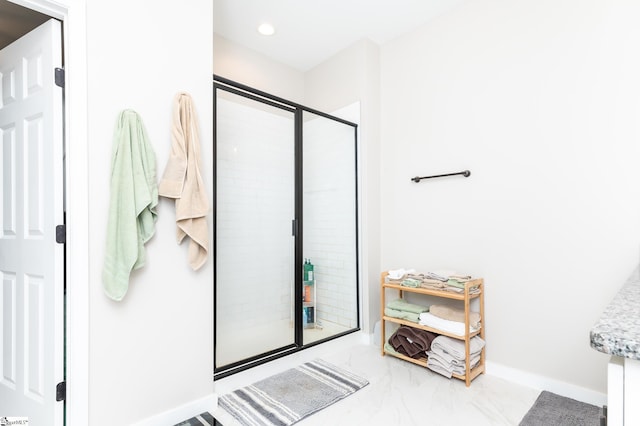 full bath with a shower stall, marble finish floor, baseboards, and recessed lighting