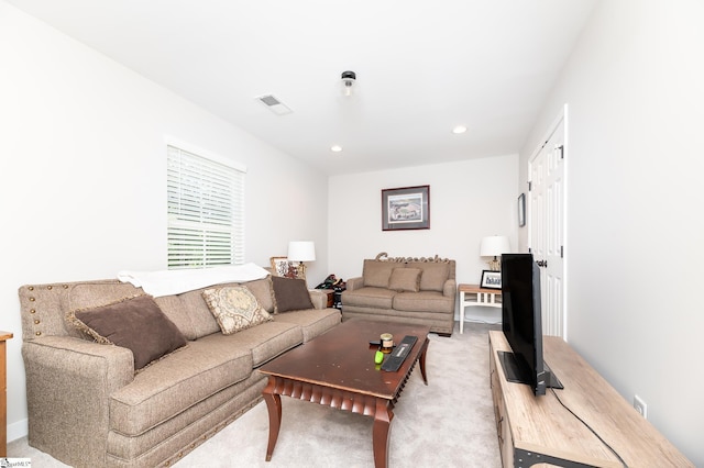 living room featuring light carpet, visible vents, and recessed lighting