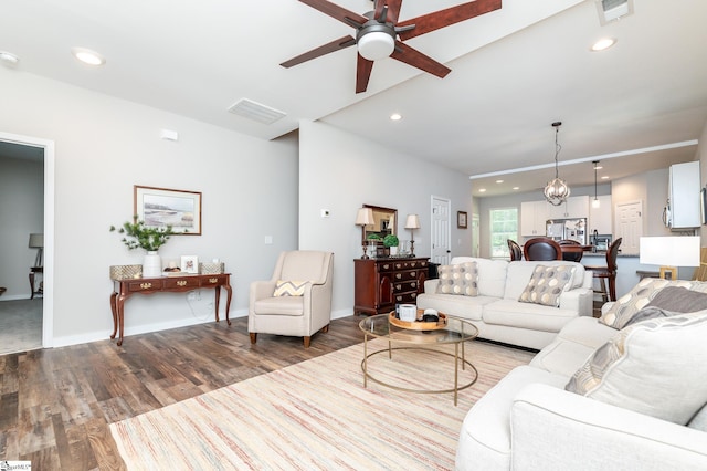 living area featuring visible vents, baseboards, ceiling fan, recessed lighting, and wood finished floors