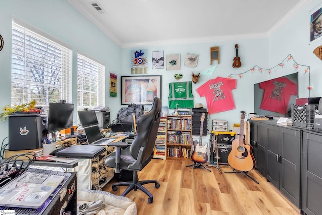 office area featuring light wood finished floors, visible vents, and ornamental molding