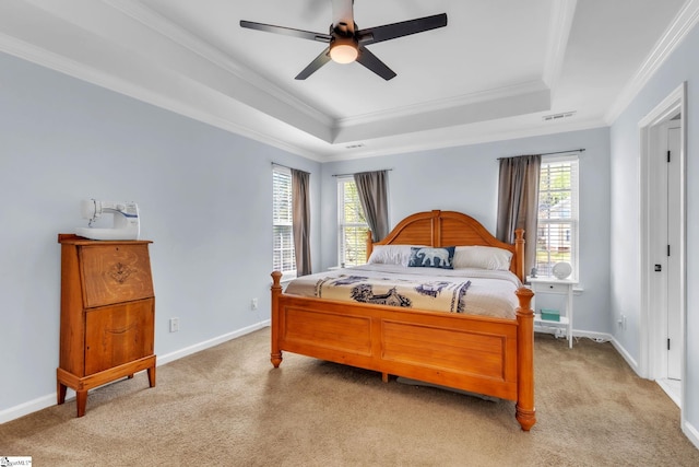 bedroom featuring visible vents, light colored carpet, ornamental molding, and a raised ceiling