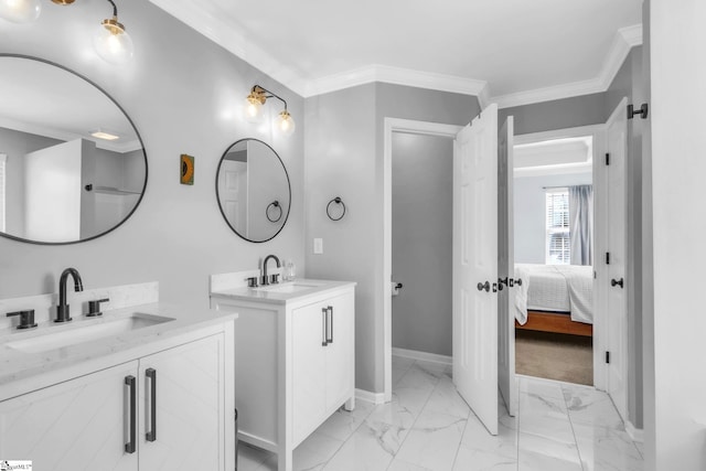 bathroom featuring a sink, ornamental molding, baseboards, and marble finish floor