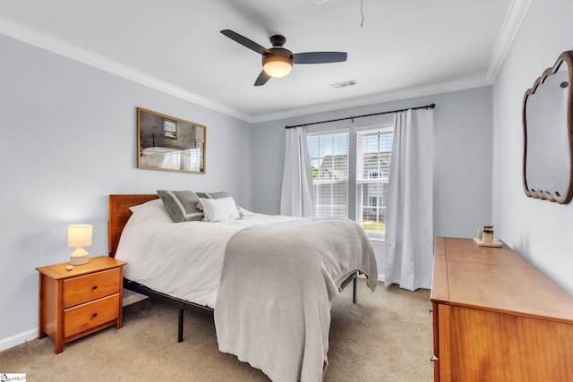 bedroom with baseboards, light carpet, crown molding, and visible vents