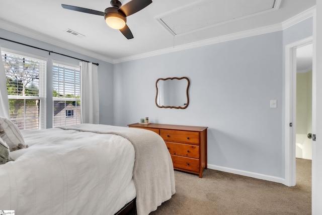 carpeted bedroom featuring visible vents, baseboards, ornamental molding, ceiling fan, and attic access