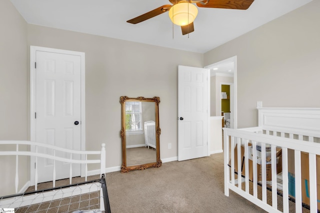 carpeted bedroom with baseboards and a ceiling fan