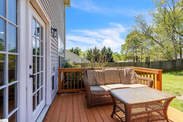 deck with outdoor lounge area and fence