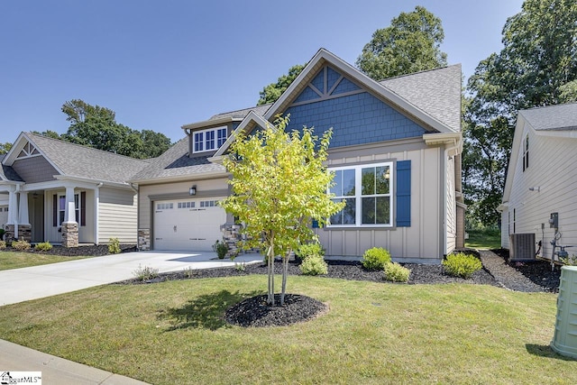 craftsman house featuring a front yard, central AC unit, a garage, board and batten siding, and driveway