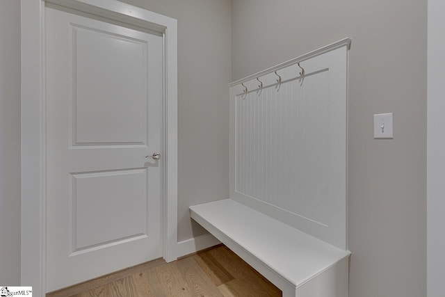 mudroom featuring light wood-style flooring and baseboards