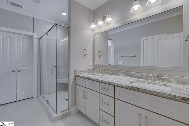 full bath with a sink, visible vents, double vanity, and a stall shower