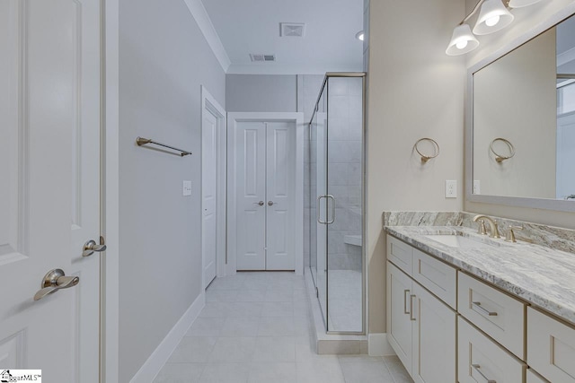 bathroom featuring visible vents, baseboards, crown molding, vanity, and a stall shower