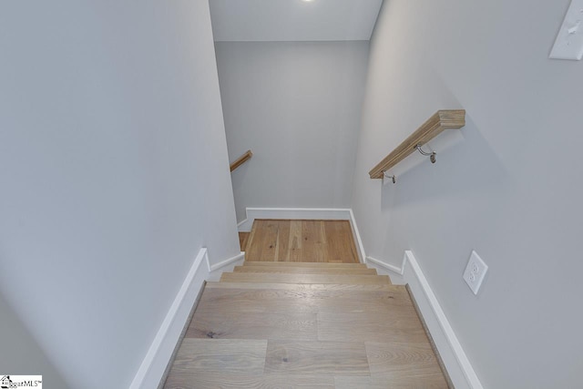 stairs featuring baseboards and wood finished floors