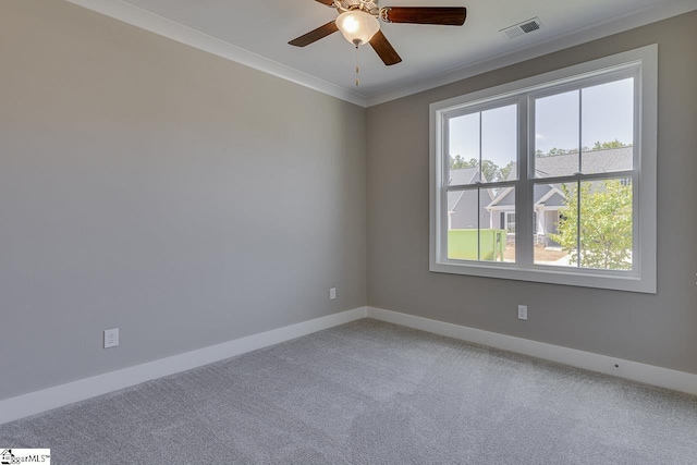 spare room with light carpet, baseboards, a ceiling fan, and visible vents