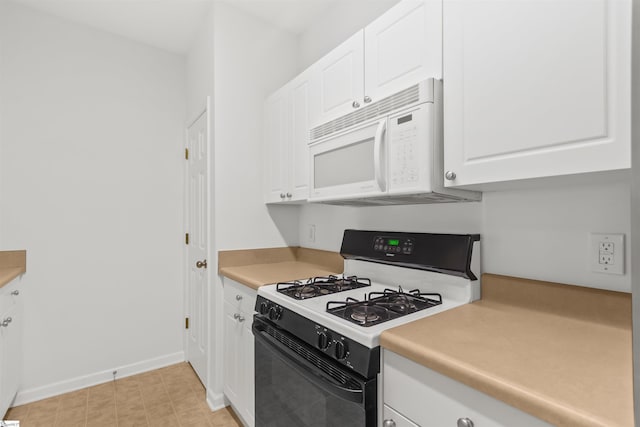 kitchen featuring white microwave, white cabinetry, light countertops, range with gas cooktop, and baseboards