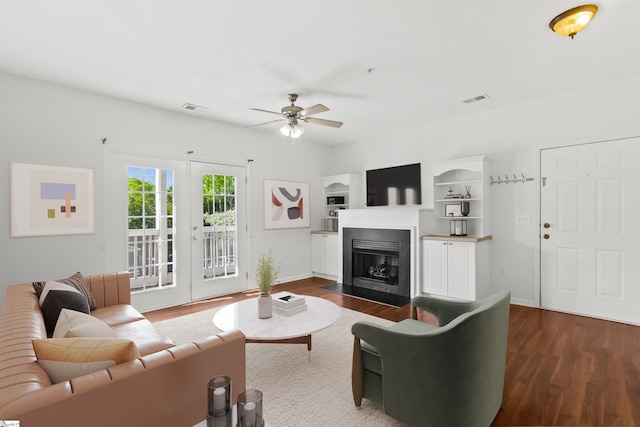 living room featuring visible vents, a ceiling fan, and wood finished floors