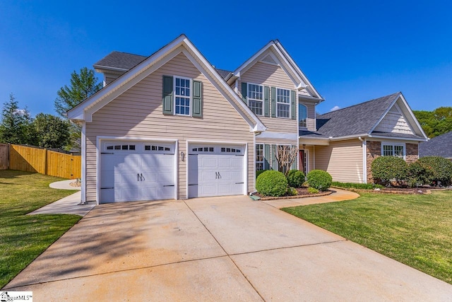 traditional-style home with an attached garage, concrete driveway, a front yard, and fence