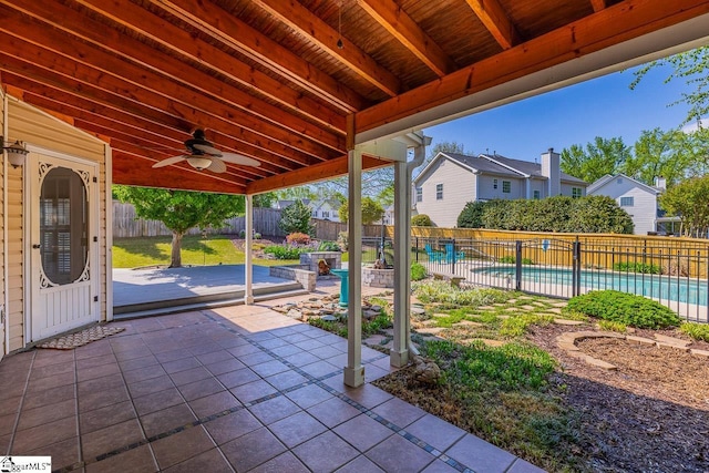 view of patio / terrace with a fenced backyard, ceiling fan, a fenced in pool, and a residential view