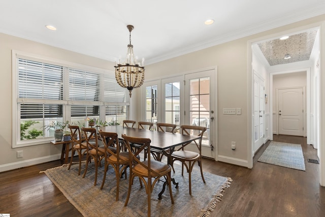 dining area featuring a wealth of natural light, a notable chandelier, and dark wood-style floors