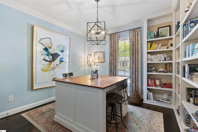 interior space featuring baseboards, dark wood-style flooring, a chandelier, crown molding, and butcher block countertops