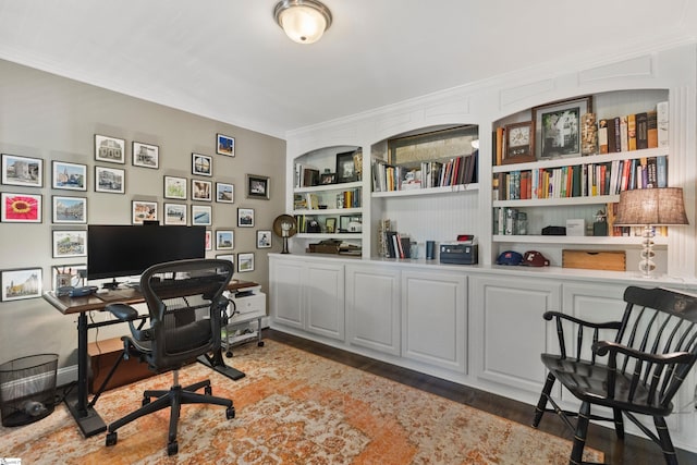 office area featuring crown molding, built in features, baseboards, and wood finished floors