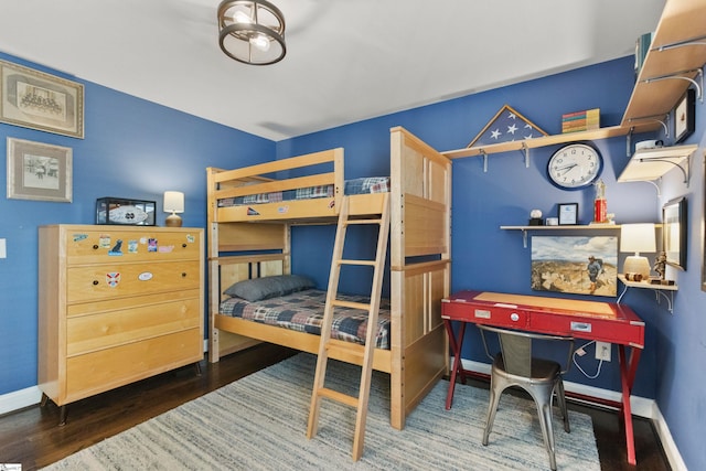 bedroom featuring baseboards and wood finished floors