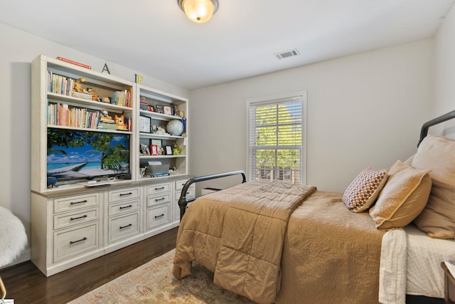 bedroom with dark wood-style flooring and visible vents
