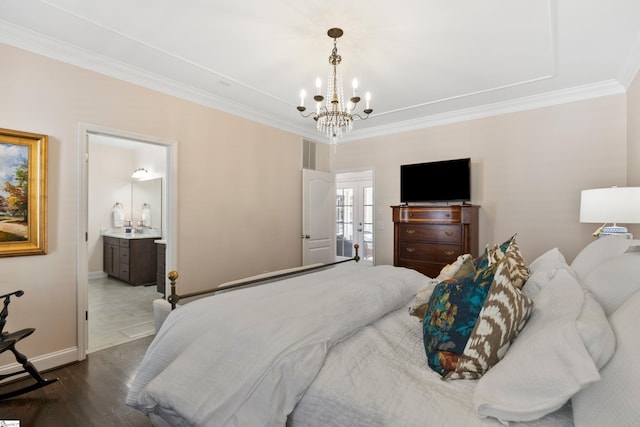 bedroom with an inviting chandelier, ornamental molding, visible vents, wood finished floors, and baseboards