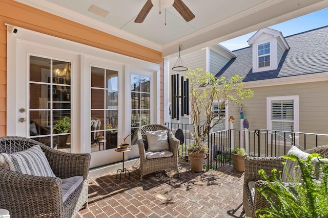 sunroom featuring ceiling fan