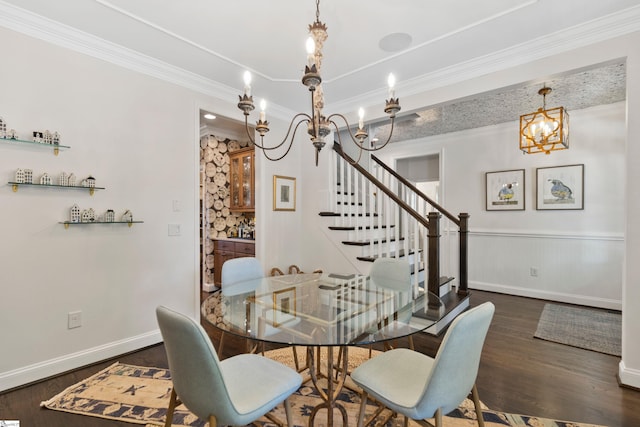 dining room with crown molding, baseboards, a notable chandelier, and wood finished floors