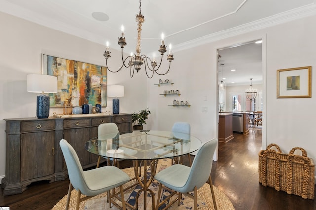 dining area featuring dark wood-style floors, an inviting chandelier, and crown molding
